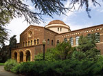 Photo of student walking in front of Kendall Hall on the Chico State campus