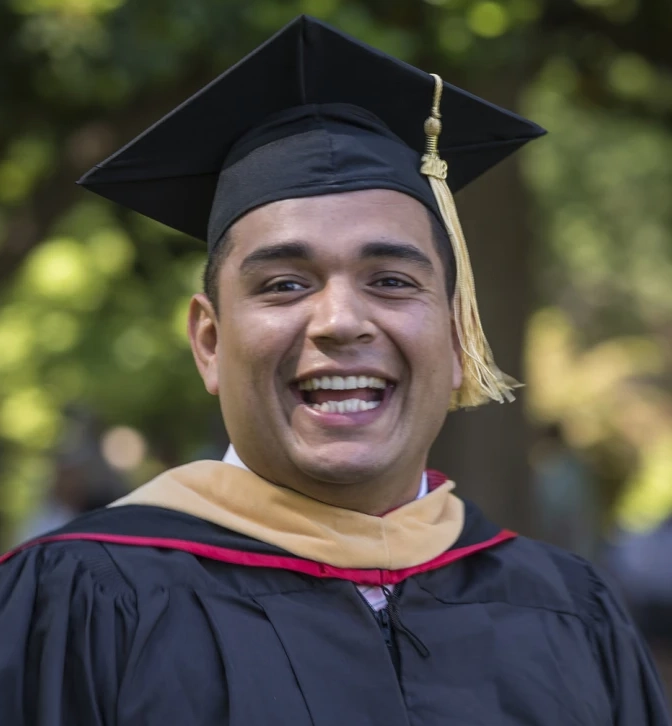 Smiling graduate in cap and gown