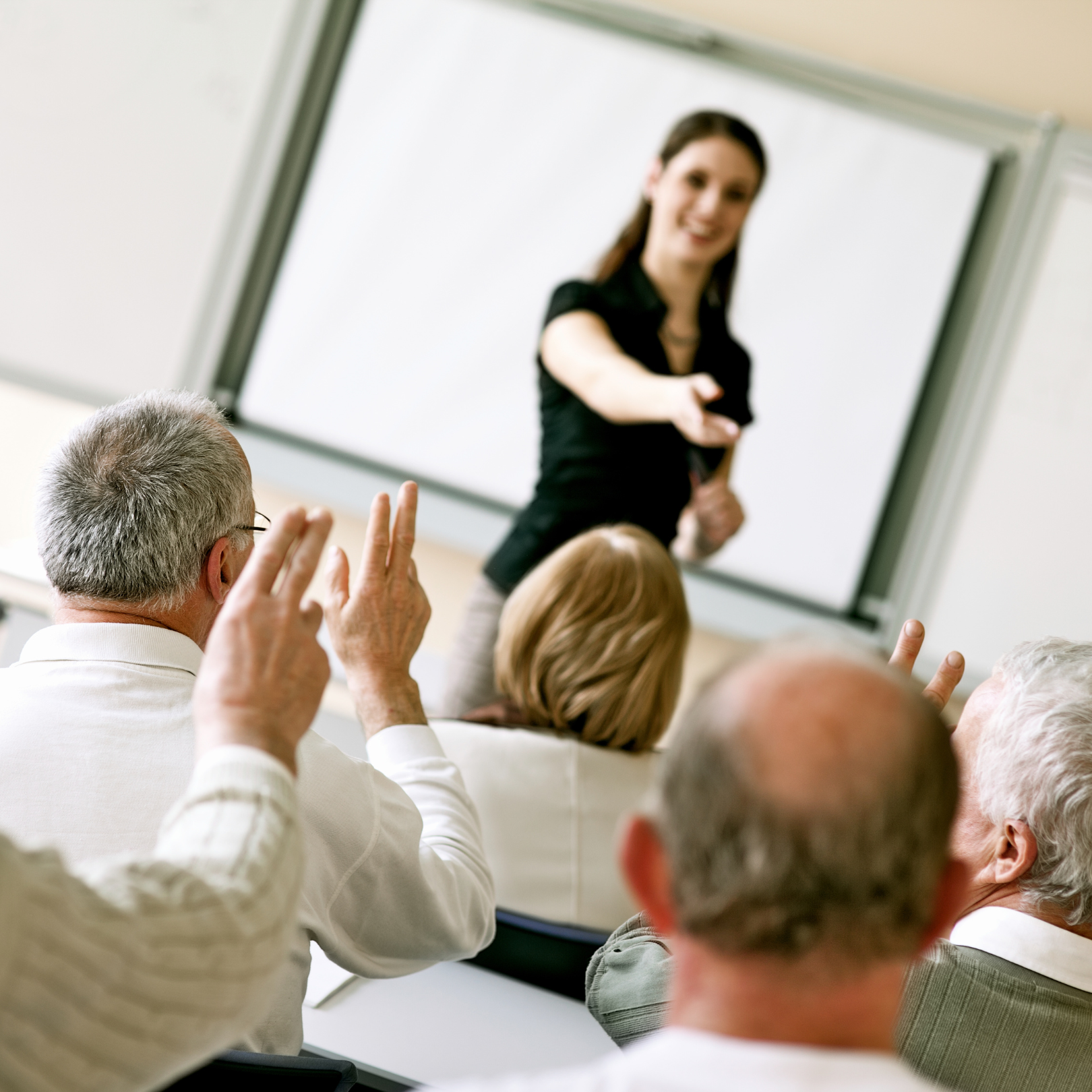 Professor lectures in front of adult learners