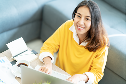 Girl with laptop looking at the camera