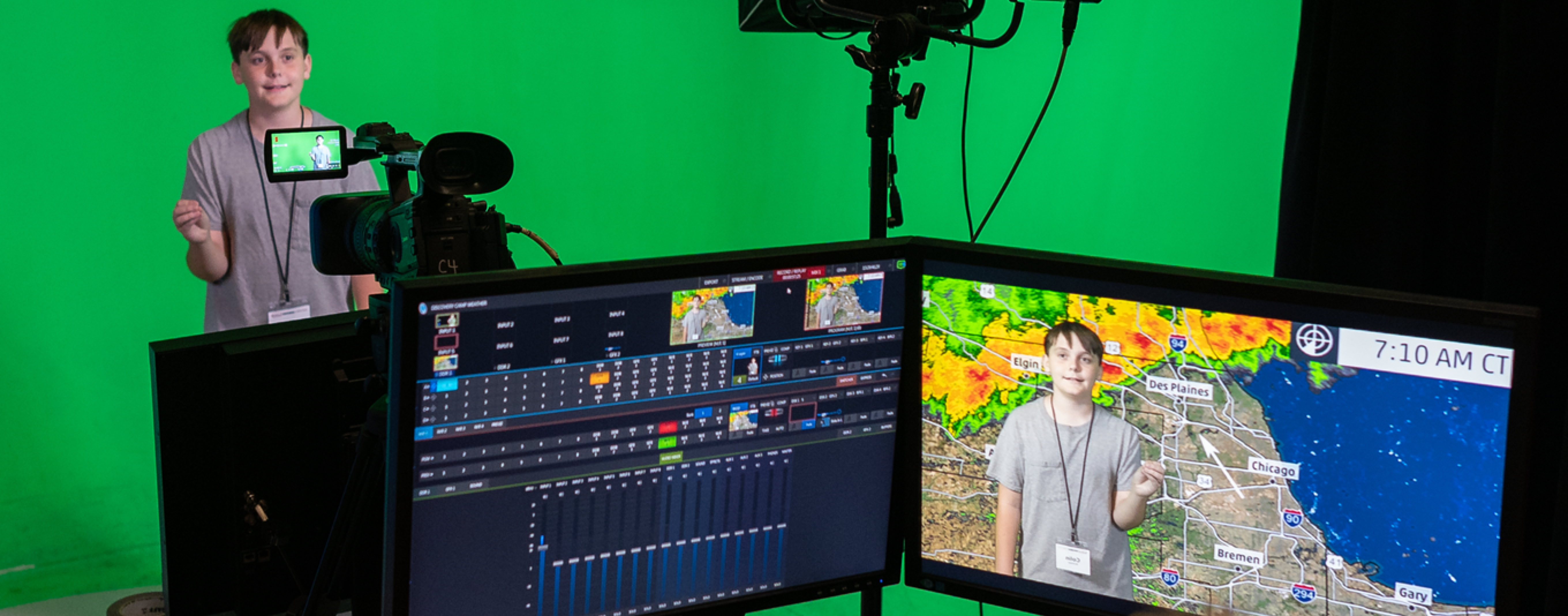 Wildcat Discovery Camp kids create a weather broadcast against a green screenweather class 