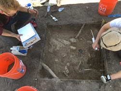 Field school participants conduct on-site excavation work